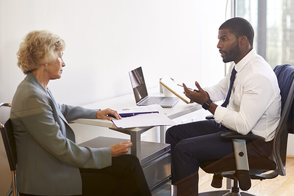 discussing-financial-costs A woman talks to a credit counsellor about her financial situation