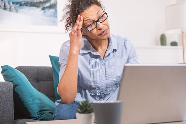 A woman researches bankruptcy on her laptop