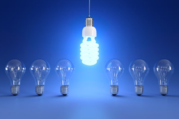 6 lightbulbs lined up with no light on and neon bulb hanging down between the 6 lightbulbs 